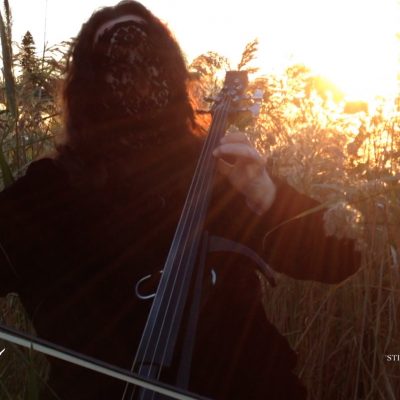 Laceface plays her cello as the sun sets on another day...or is it rising?